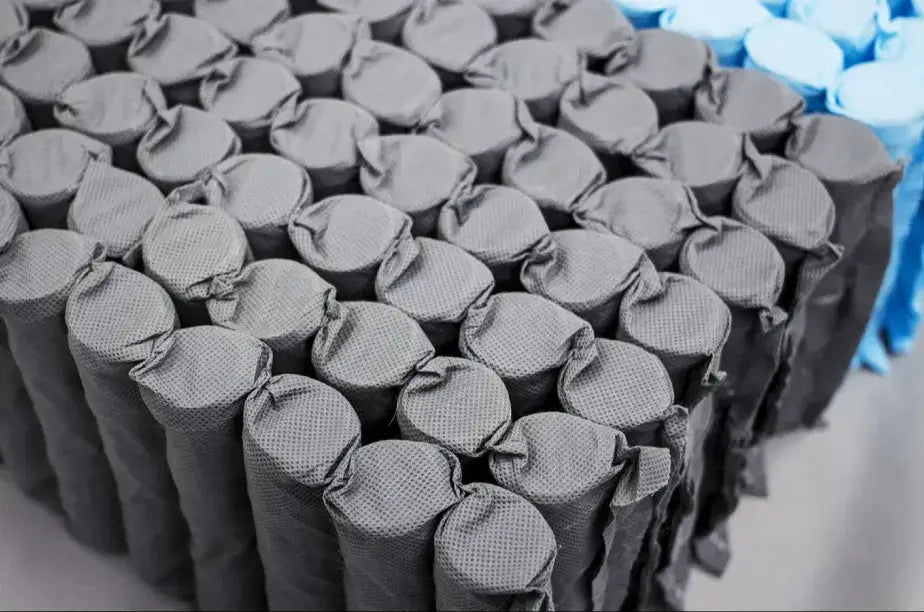Close-up of high spring count pocketed coil mattress springs wrapped in fabric for support